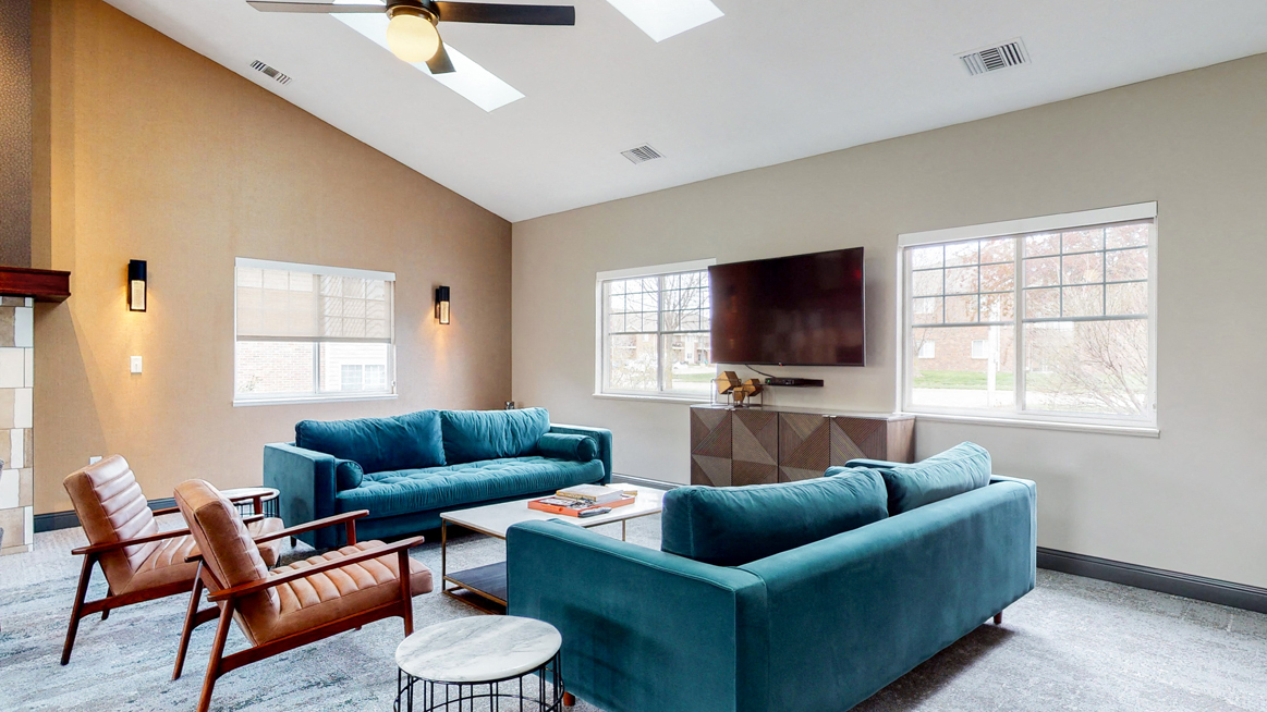 Casual sitting area with TV at the community clubhouse at The Northbrook Apartments