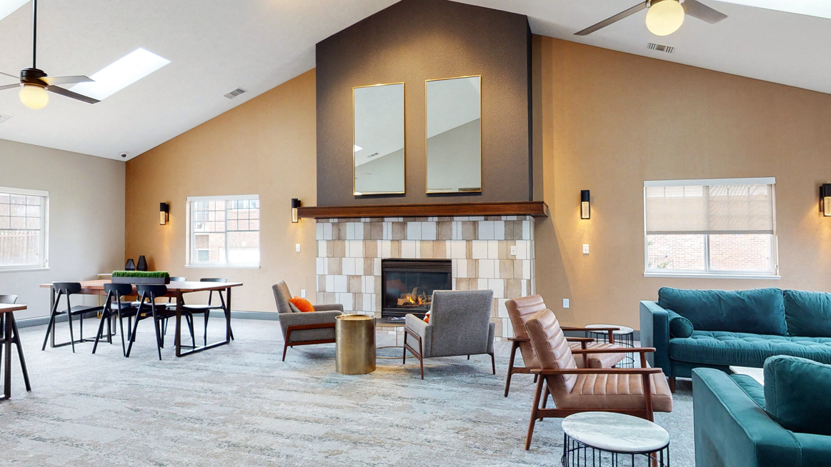 Large clubhouse with vaulted ceiling, fireplace and multiple sitting areas at the Northbrook Apartments