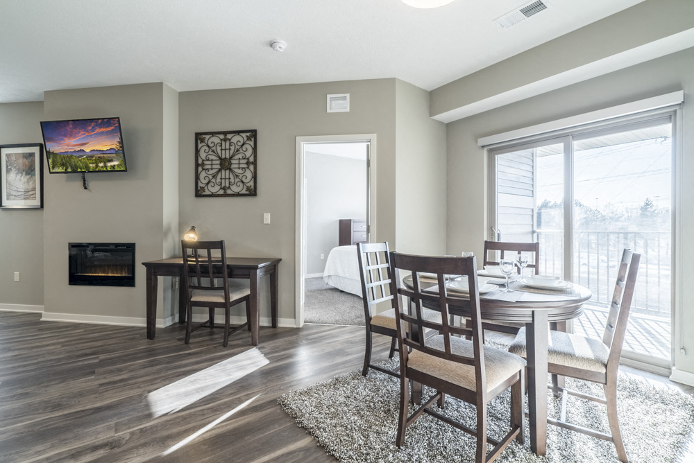 Dinning room table and desk in the living space at The Villas at Mahoney Park