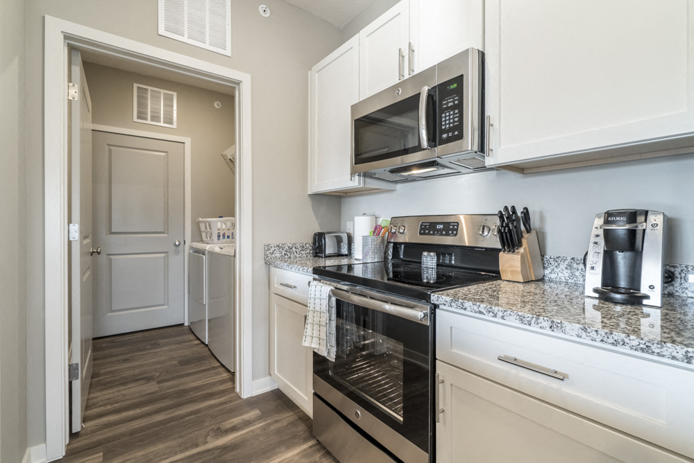 Kitchen including stainless steel smooth top stoves at The Villas at Mahoney Park