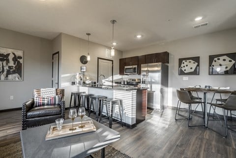 a living room with a kitchen and a dining table