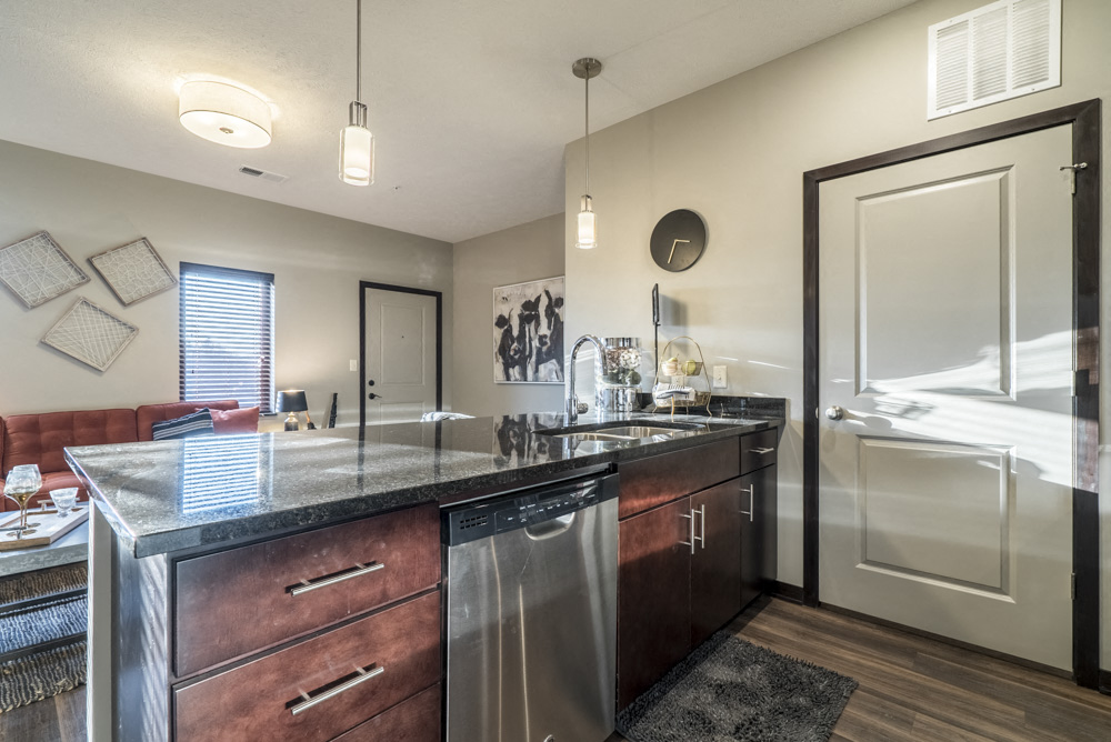 Kitchen with dark cabinets and dark granite counter tops at The Villas at Mahoney Park