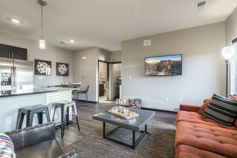 Modern and inviting open layout of living room and kitchen at The Villas at Mahoney Park