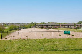 Fenced dog run with mulch and agility course