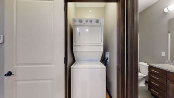 a stacked washer and dryer in a closet space