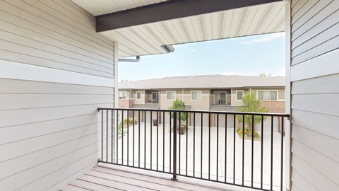 spacious balcony with rail and view of villas