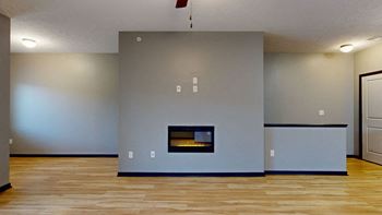 a living room with a fireplace and hardwood floors