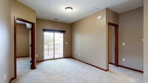 a living room with a sliding glass door to the balcony