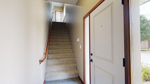 a private staircase leading from the front door to the