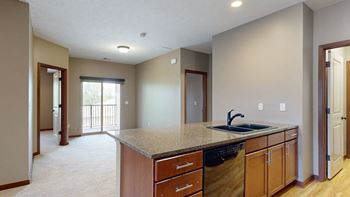 a kitchen counter top with a stone sink in front of a dining room