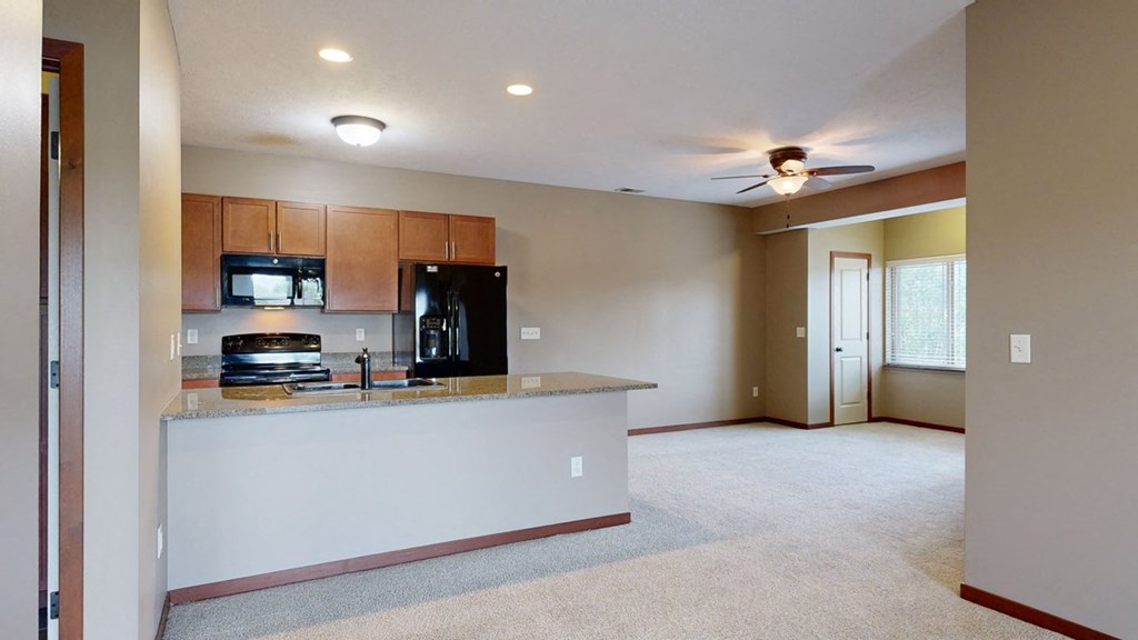 an adjacent living room and kitchen