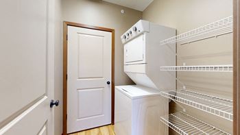 the walk in pantry and laundry space with a door to the mechanical room