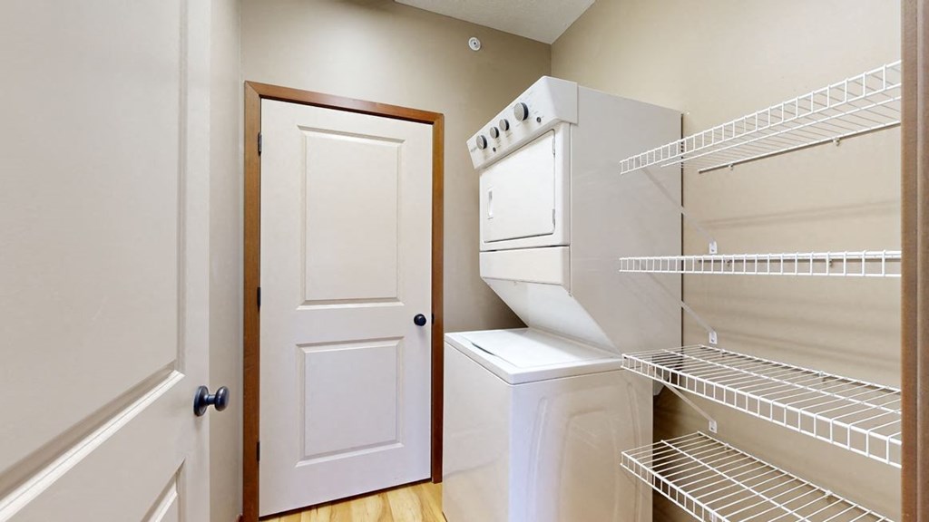 the walk in pantry and laundry space with a door to the mechanical room