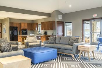 Clubhouse interior with kitchen and seating at Villas of Omaha townhome apartments in northwest Omaha NE 68116