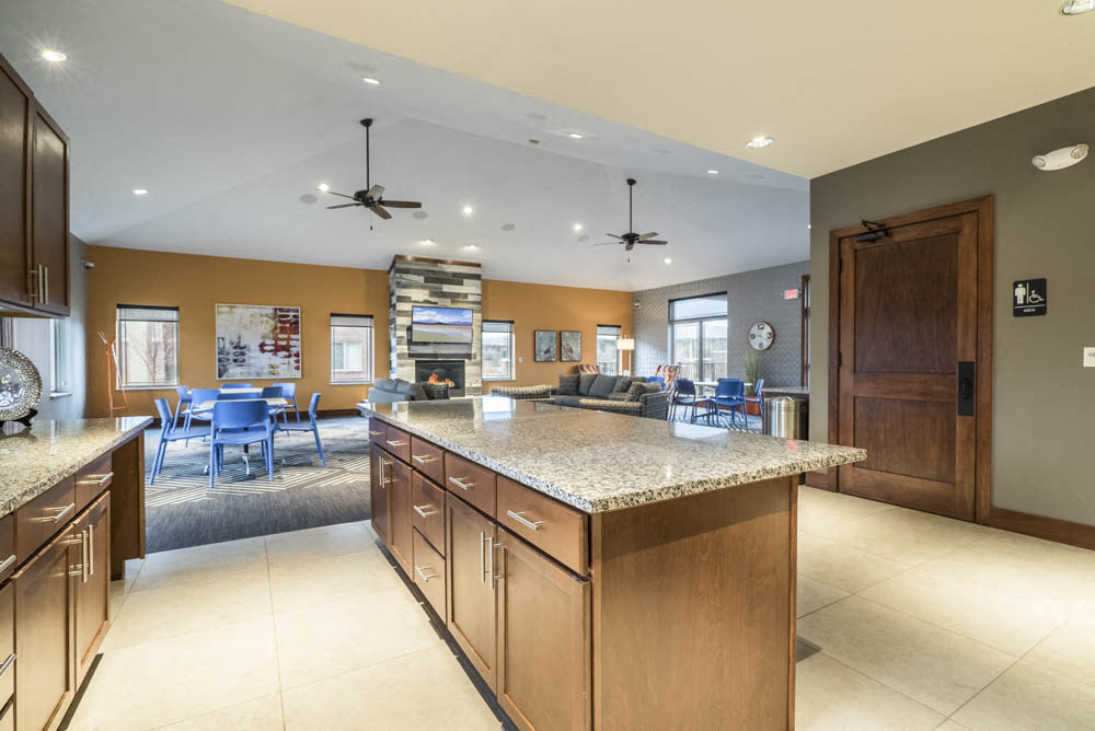 Kitchen with island in clubhouse at Villas of Omaha townhome apartments in northwest Omaha NE 68116