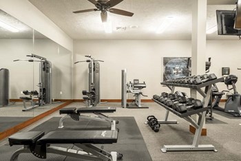 Fitness center with free weights and weightlifting machines at Villas of Omaha townhome apartments in northwest Omaha NE 68116 - Photo Gallery 15