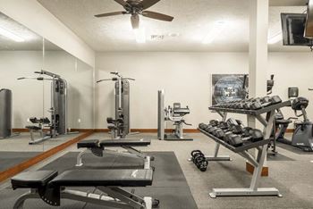Fitness center with free weights and weightlifting machines at Villas of Omaha townhome apartments in northwest Omaha NE 68116