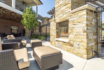 Outdoor fireplace with cushy lounge chairs at Villas of Omaha in northwest Omaha NE 68116 - Photo Gallery 20