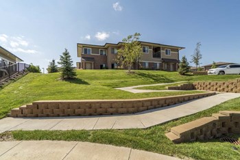 Villa building on top of green hill at Villas of Omaha townhome apartments in northwest Omaha NE 68116 - Photo Gallery 45