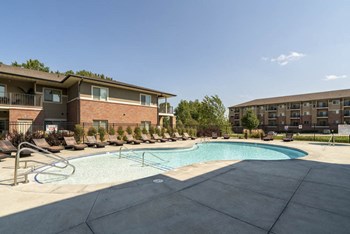Resort-style pool with lounge chairs at Villas of Omaha in northwest Omaha NE 68116 - Photo Gallery 46