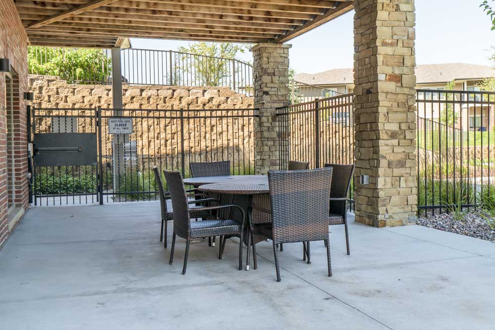 Outdoor seating by pool at Villas of Omaha in northwest Omaha NE 68116