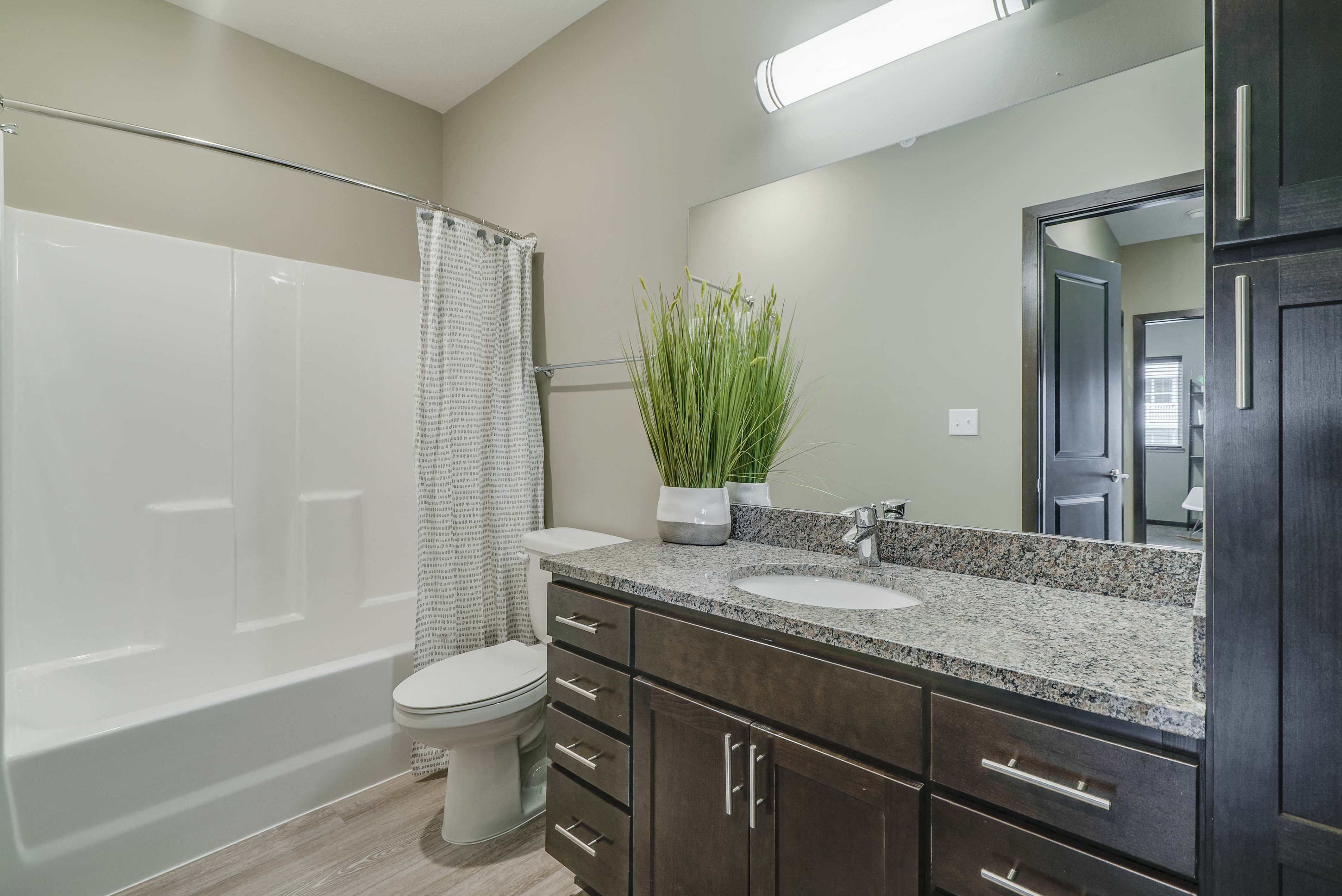 Bathroom with granite countertops at WH Flats new luxury apartments in south Lincoln NE 68516