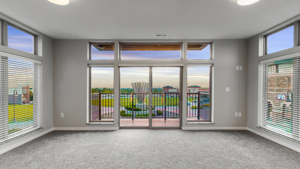 Large living area with floor to ceiling windows providing lots of natural light at WH Flats