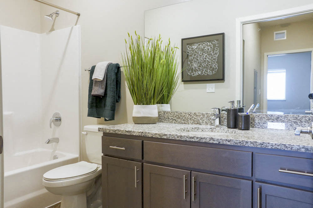 Bathroom with granite countertops at WH Flats new luxury apartments in south Lincoln NE 68516