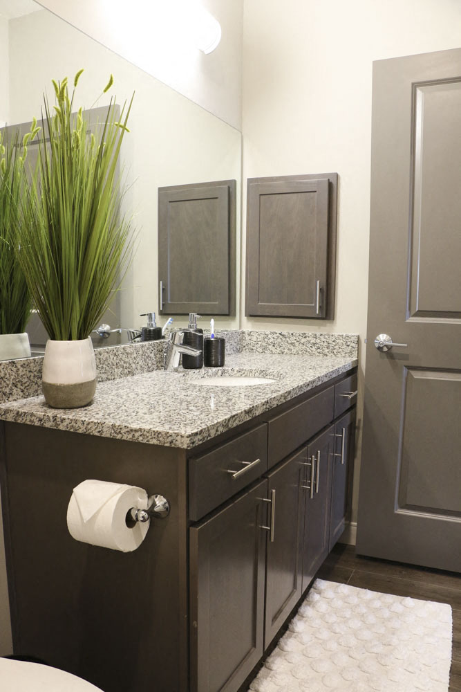 Bathroom with granite countertops at WH Flats new luxury apartments in south Lincoln NE 68516