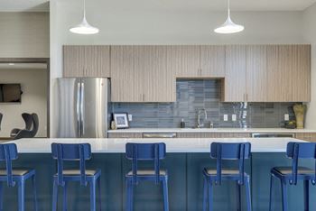 Modern blue chairs at clubhouse kitchen at WH Flats luxury apartments in south Lincoln NE