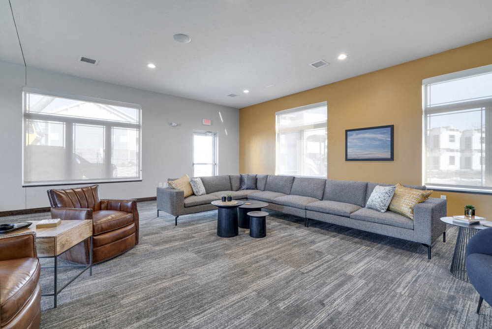 Clubhouse TV lounge with sofa and chairs at WH Flats luxury apartments in south Lincoln NE