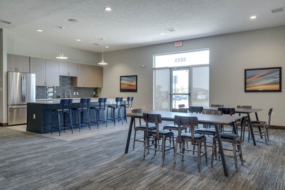 WH Flats luxury apartments clubhouse with kitchen and tables