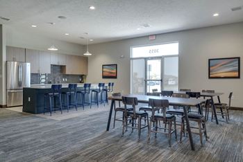 WH Flats luxury apartments clubhouse with kitchen and tables