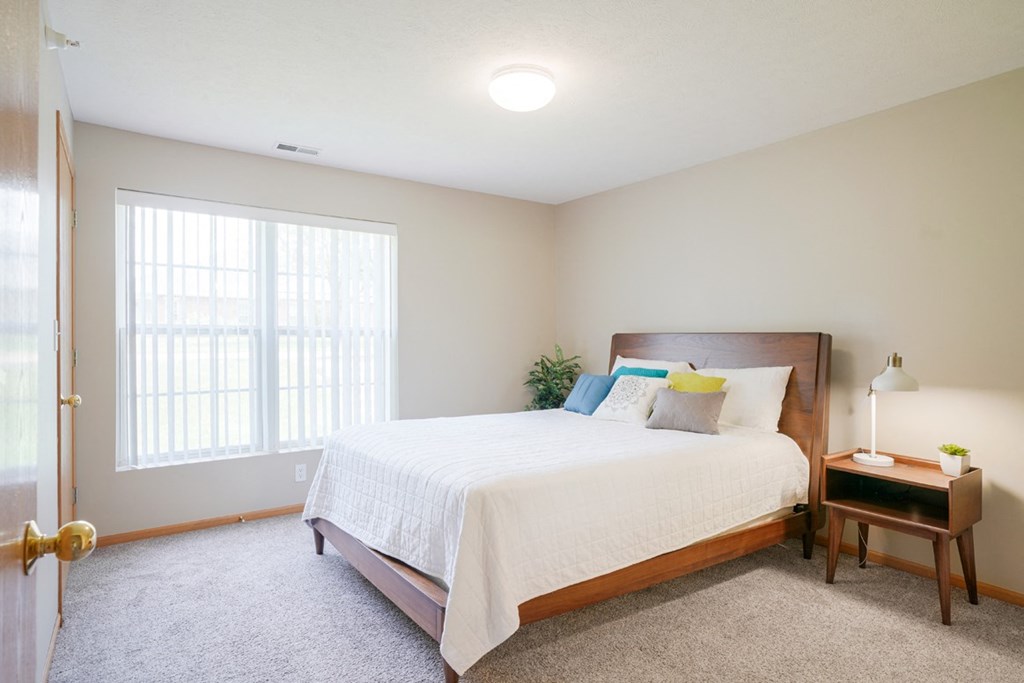 A furnished bedroom with a large bed and a window at Williamsburg Park