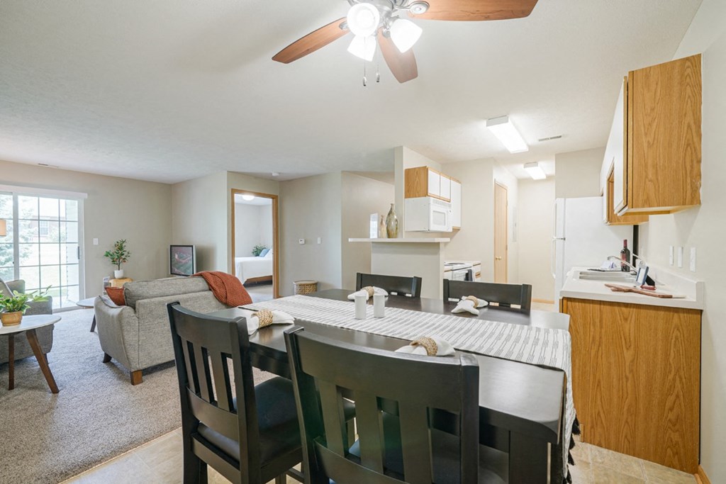 the view of the living room and dining room with table and chairs