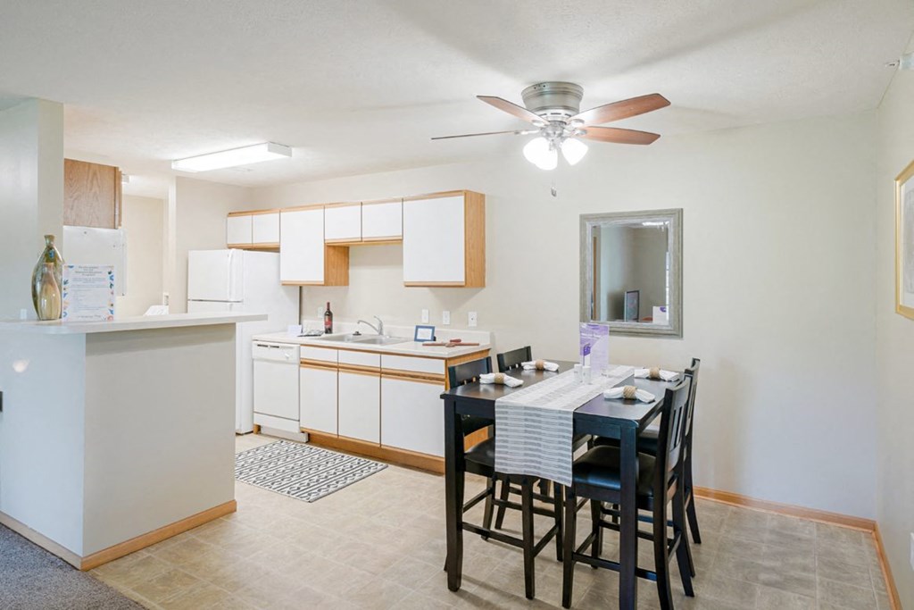 a kitchen and dining room with a table and chairs