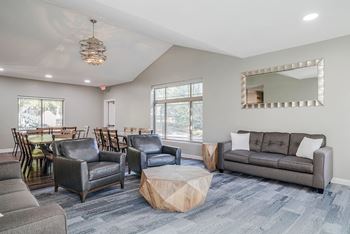 a seating area with chairs and couches next to a dining area