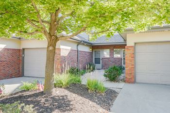 the front of a two villas with two garage doors