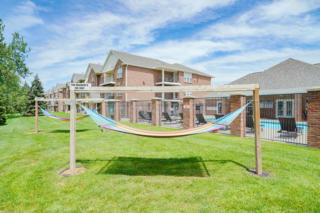 a pair of hammocks near the community clubhouse and pool