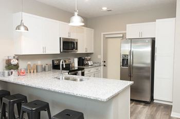 white cabinet kitchen with bar stool seating