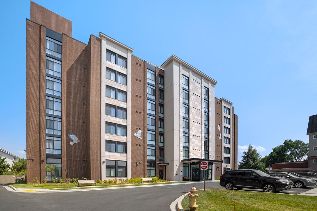 a view of the front of the building with a car parked in front of it