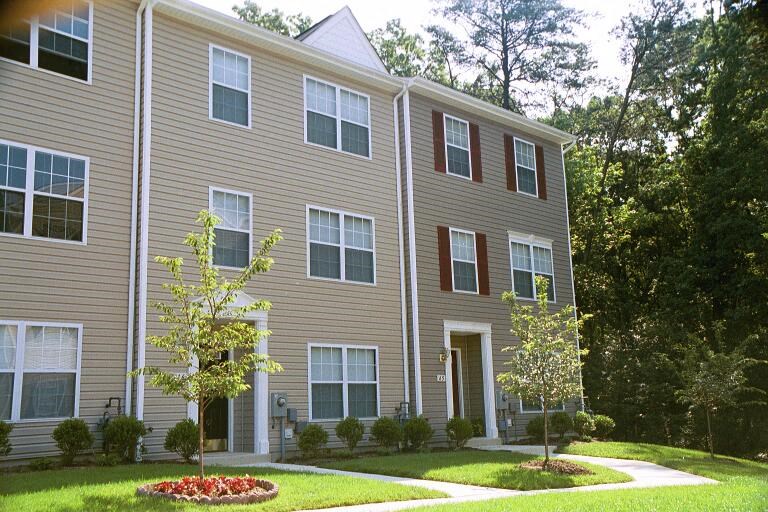 a large apartment building with trees in front of it
