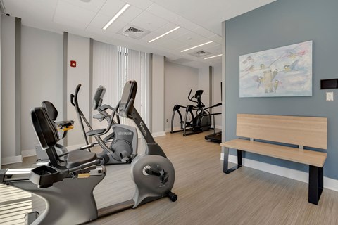 a room filled with exercise equipment and a bench