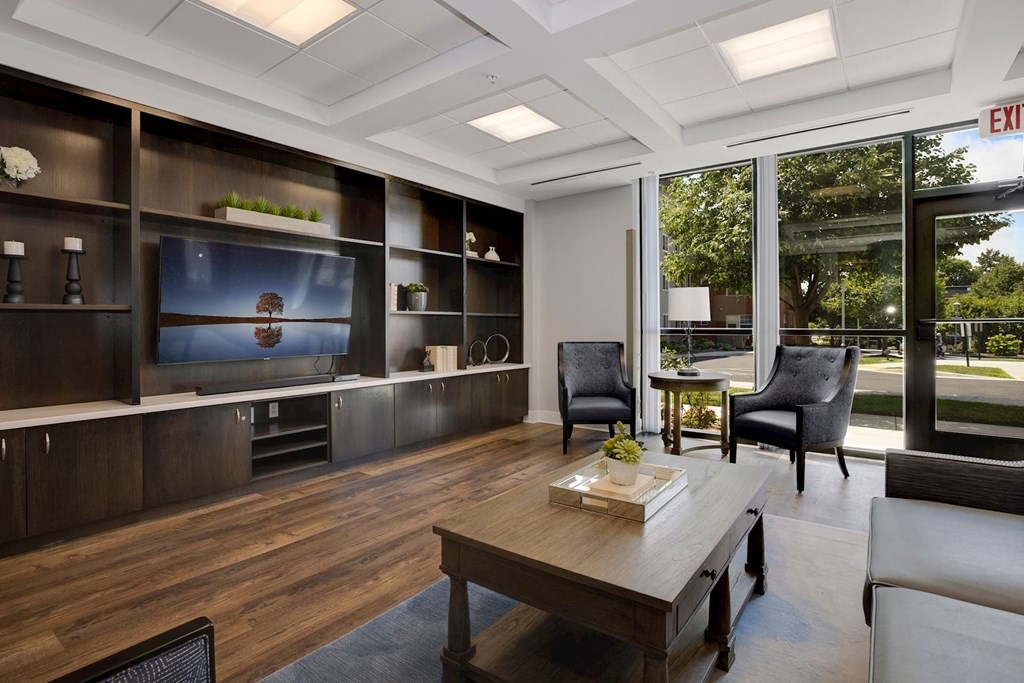 a living room filled with furniture and a large window