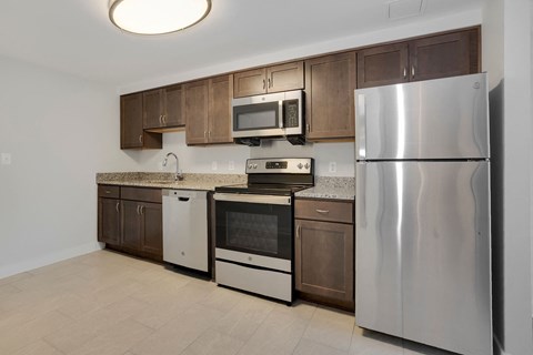 a kitchen with stainless steel appliances and wooden cabinets