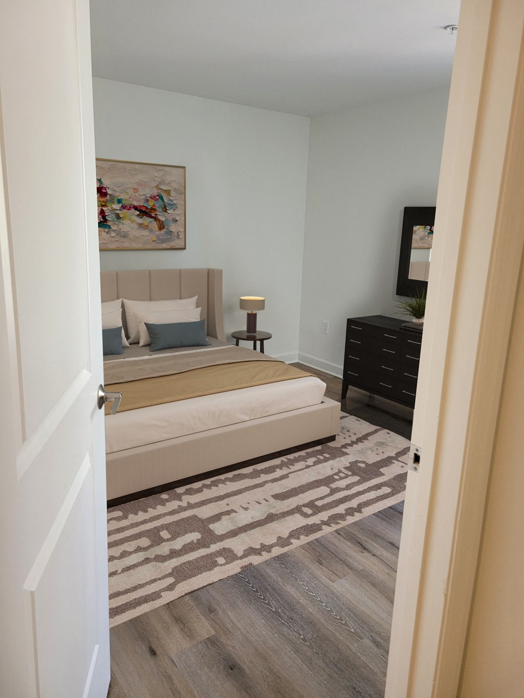 a bedroom with a bed and a dresser