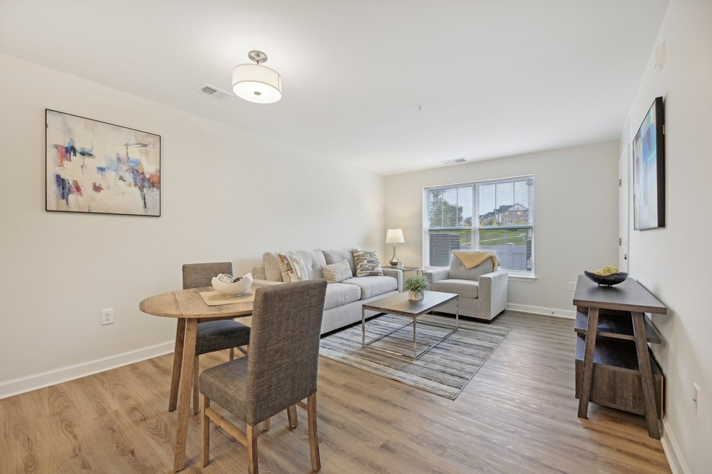 A living room with a couch, chair, and table.