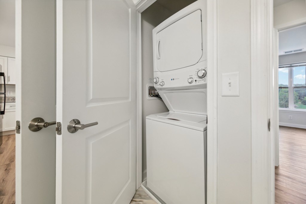 A white oven is built into a white door.