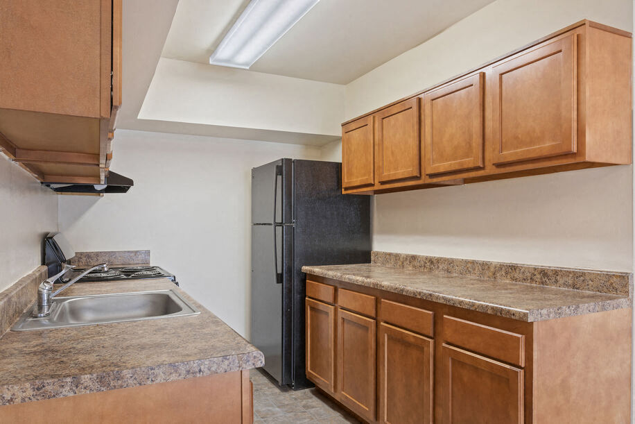 a kitchen with a sink and a refrigerator