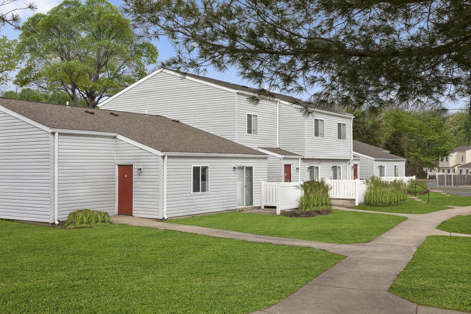 a row of white houses with a red door